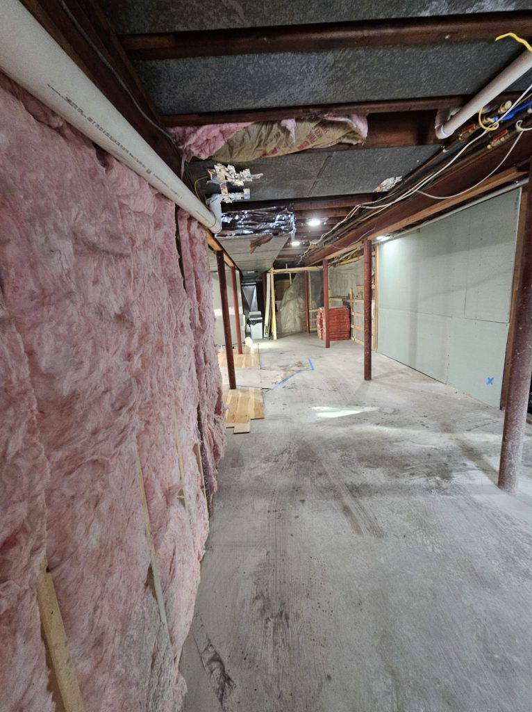 The bathing area before work, with exposed structure and mechanicals.