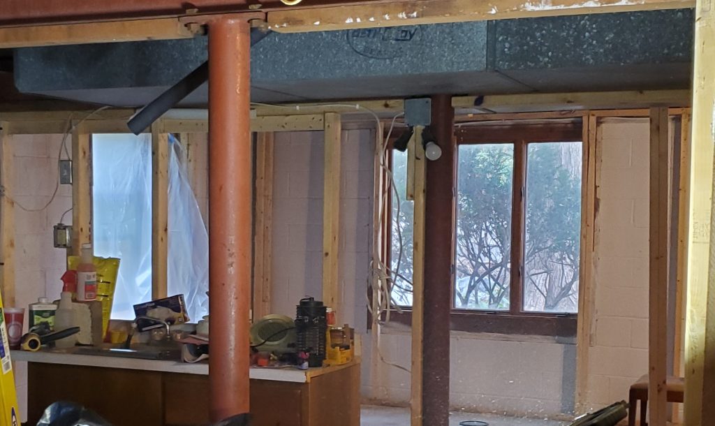 The bedroom shell before finishing, with exposed framing and unfinished surfaces.